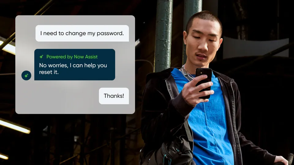 a man holding a smartphone uses ServiceNow's AI assistant to change his password